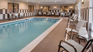 A hotel pool area with multiple lounge chairs and a long pool. - Hampton Inn Lincoln Airport (Lincoln)
