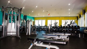 A gym with various exercise equipment, including weight machines and dumbbells. - Bowman Lodge & Convention Center (Bowman)