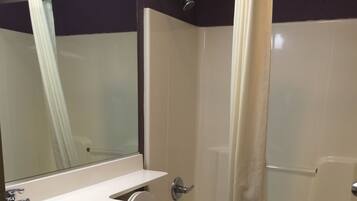 A bathroom with a sink, toilet, and bathtub.