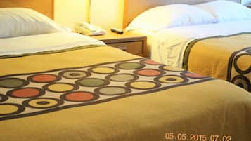 Camera d'albergo con due letti, un comodino con telefono e telecomando, e una lampada a parete.