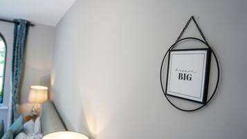 A framed picture with the text "dream BIG" on a wall.