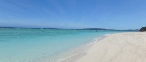 Beach nearby, white sand, beach umbrellas, beach towels