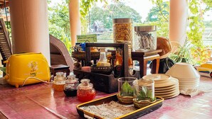 Une table sur laquelle se trouvent divers objets de cuisine, notamment un grille-pain jaune, des bocaux, des verres et des assiettes.
