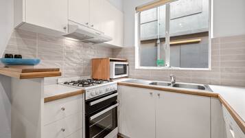 Two Bedroom Apartment | Private kitchen | Full-sized fridge, microwave, oven, stovetop