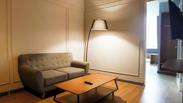 A modern living room with a sofa, a coffee table, and a floor lamp.
