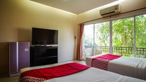A hotel room with two beds, a TV, a refrigerator, and a large window with a balcony view. - OYO 384 Ban Sabaidee (Ayutthaya)