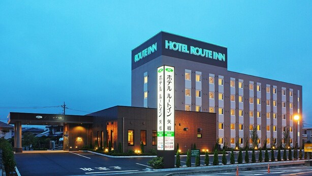 A modern hotel building with a prominent sign reading "HOTEL ROUTEIN".