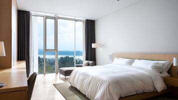 Habitación de hotel moderna con una cama grande, un escritorio y vistas al exterior.