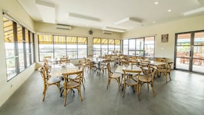 A spacious conference room with large windows and a view of the outdoors. - Best Inn Hotel (Balikpapan)