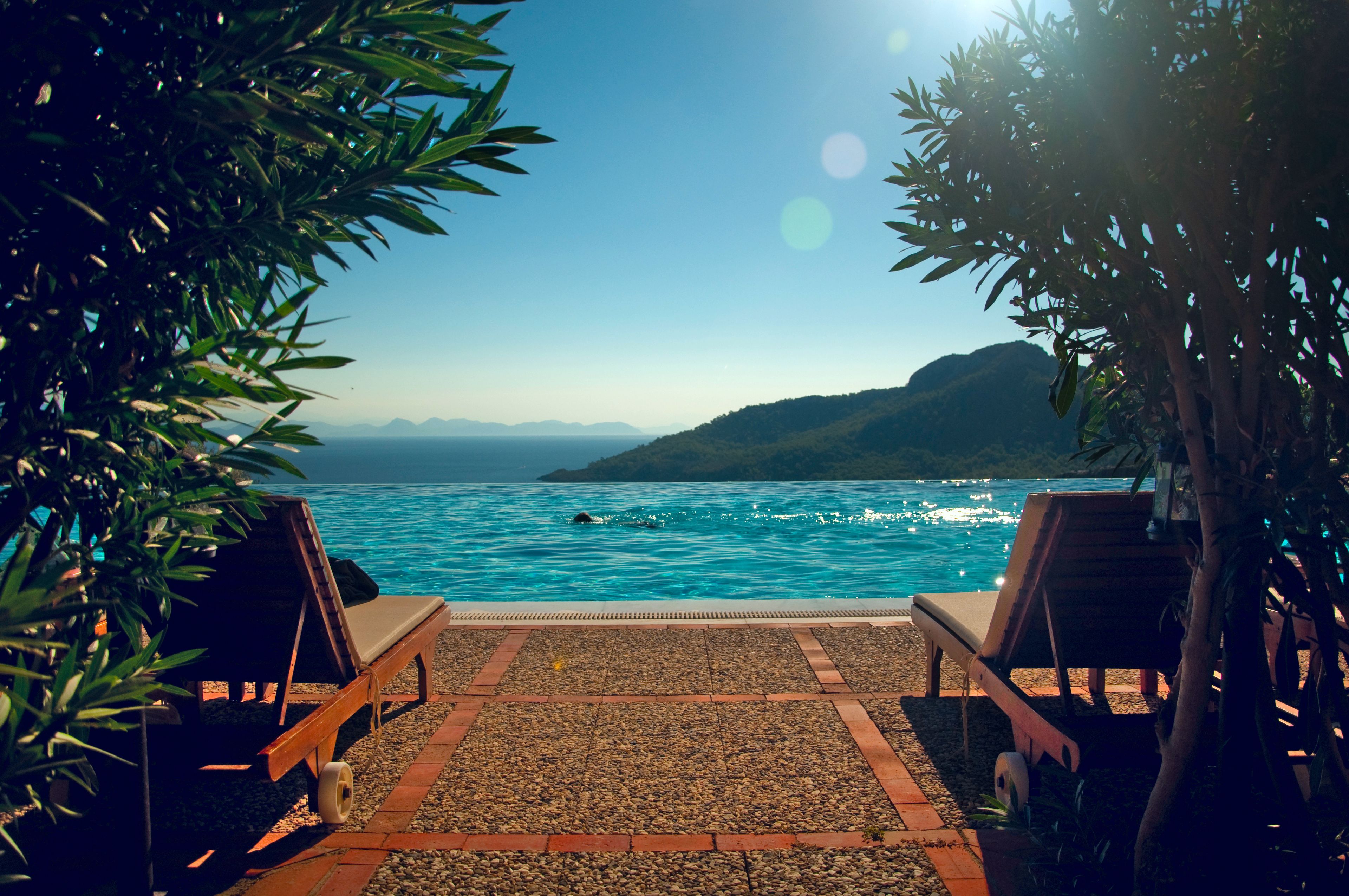 Outdoor pool, an infinity pool, open 7 AM to 7 PM, pool umbrellas