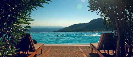 Outdoor pool, an infinity pool, open 7 AM to 7 PM, pool umbrellas
