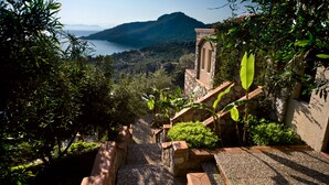 A stone staircase leading to a terrace with a view of a lake and mountains. - Dionysos Hotel (Marmaris)