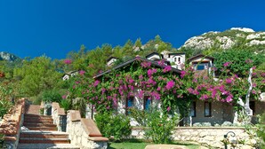 A hillside property with terraced stone steps leading to a building. - Dionysos Hotel (Marmaris)
