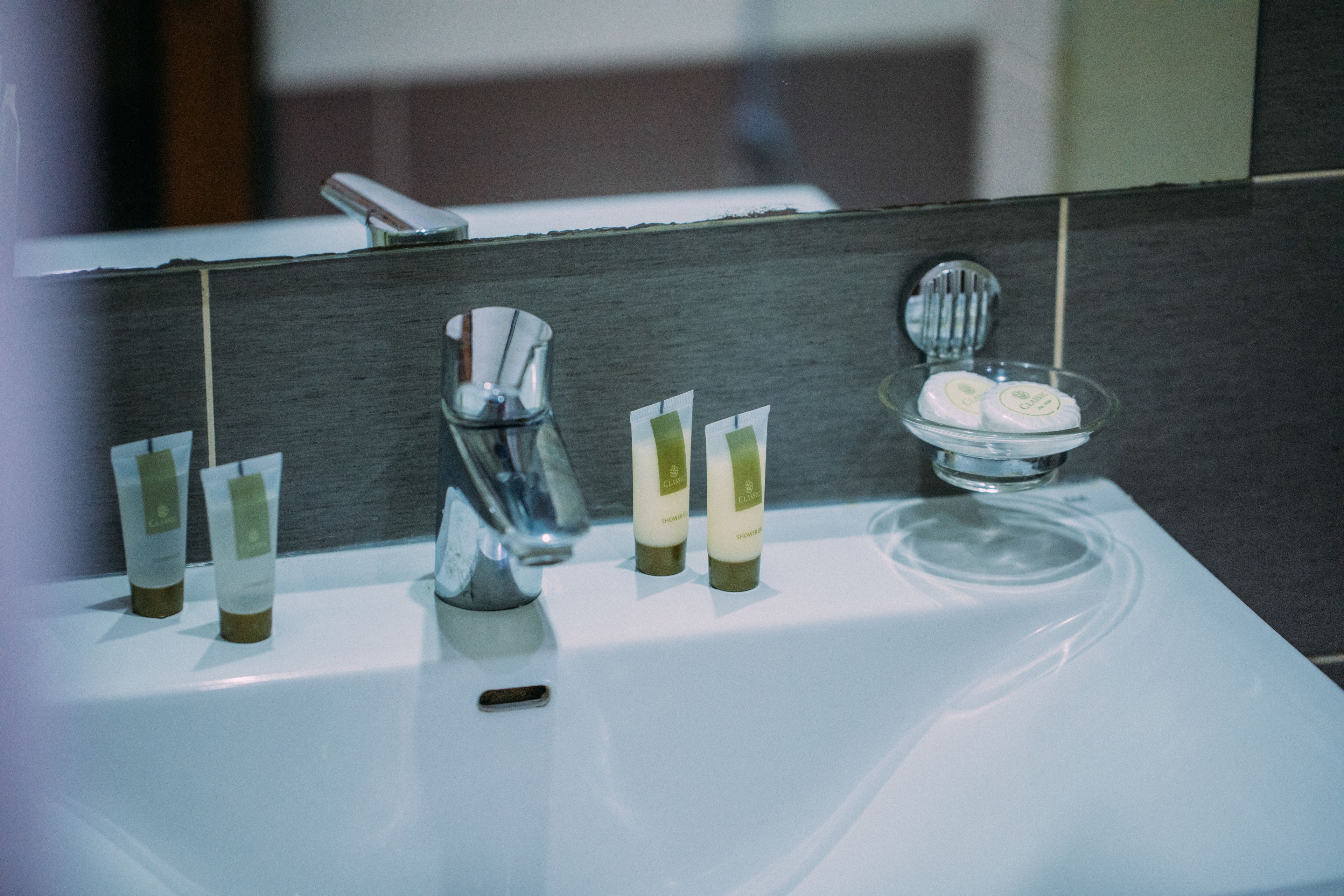 A bathroom sink with toiletries and a mirror.