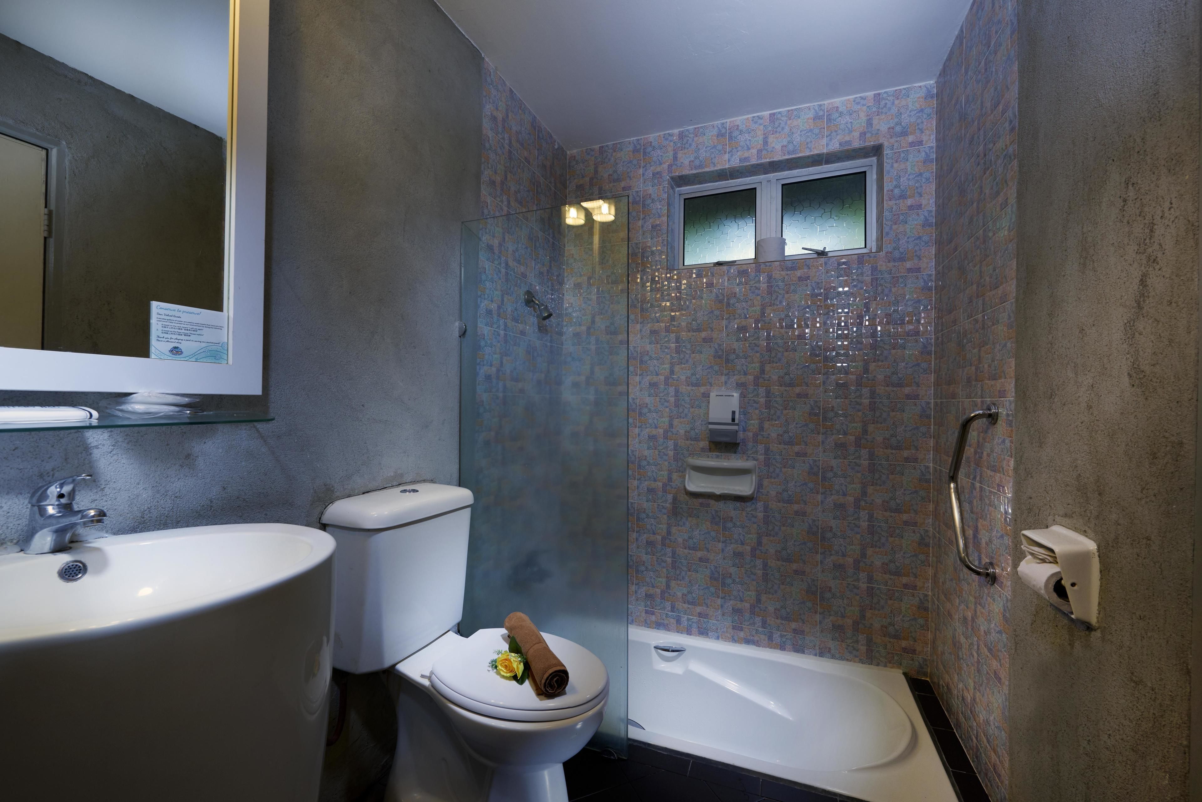 A bathroom with a white sink, toilet, and bathtub.