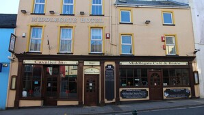 A building with a sign reading "Middlegate Hotel" and "Cavalier Inn & Function Room" indicating it houses a hotel and a function room. - The Middlegate Hotel (Pembroke)