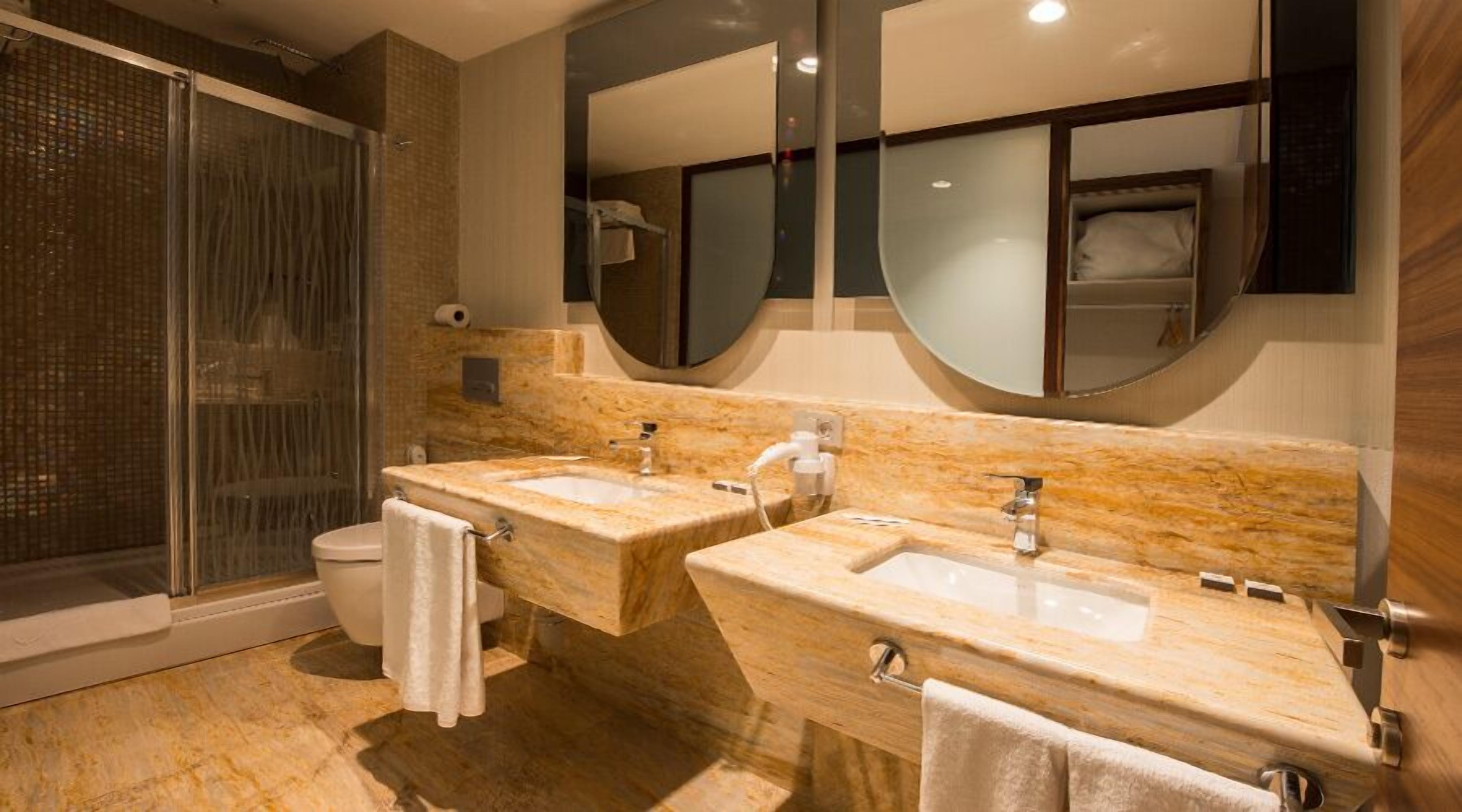 suite, 1 queen bed, refrigerator | bathroom | rainfall showerhead, free toiletries, hair dryer, slippers