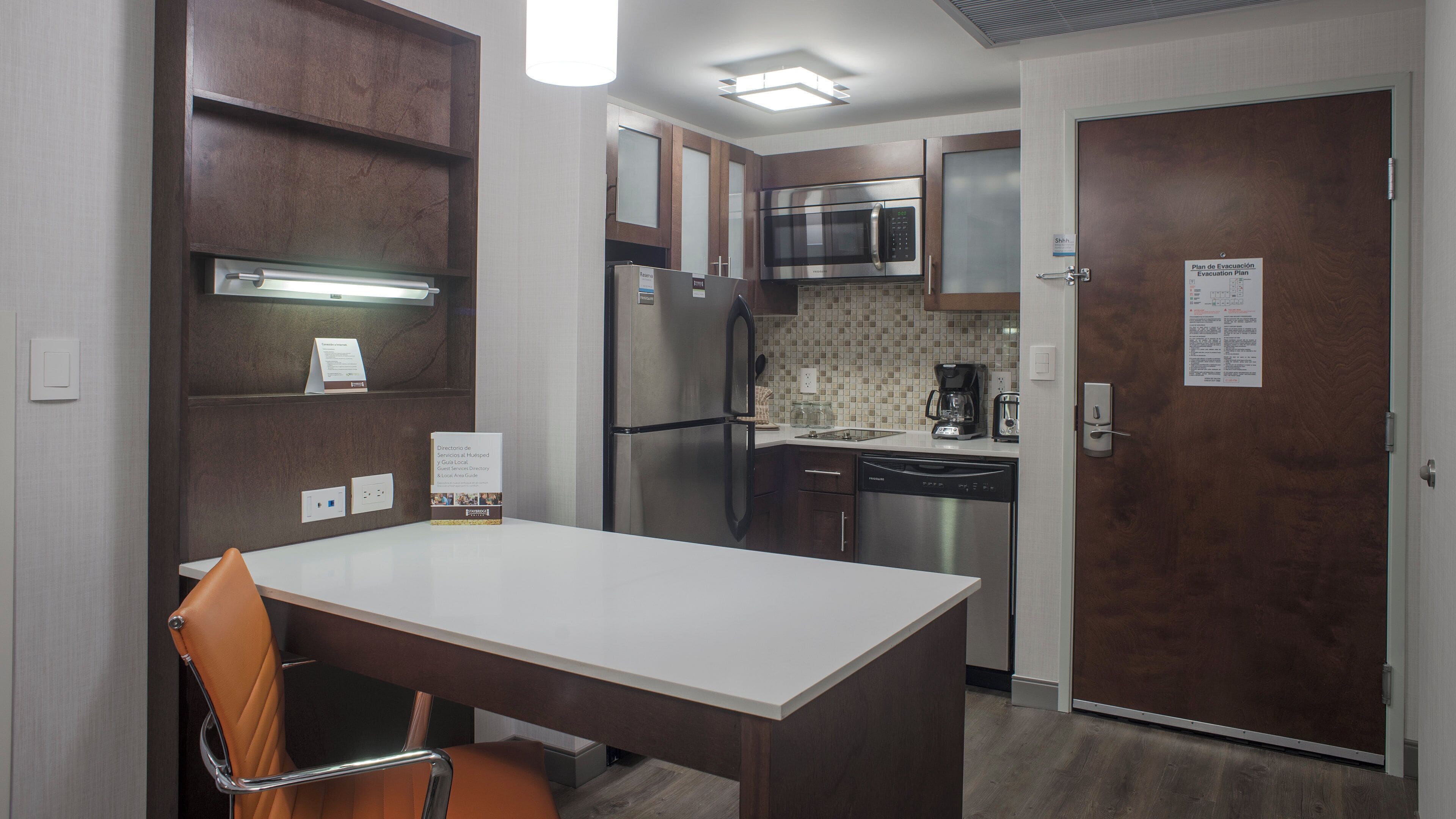 A compact kitchen with a refrigerator, microwave, and coffee maker.