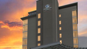 A modern hotel with a prominent "DOUBLE TREE by Hilton" sign, featuring a large glass facade and a covered entrance area. - DoubleTree by Hilton Asheville Downtown (Asheville)