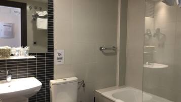 A bathroom with a toilet, sink, and bathtub.