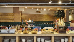 A buffet setup with various food items and utensils. - Hôtel LIGO by HappyCulture (Marseille)