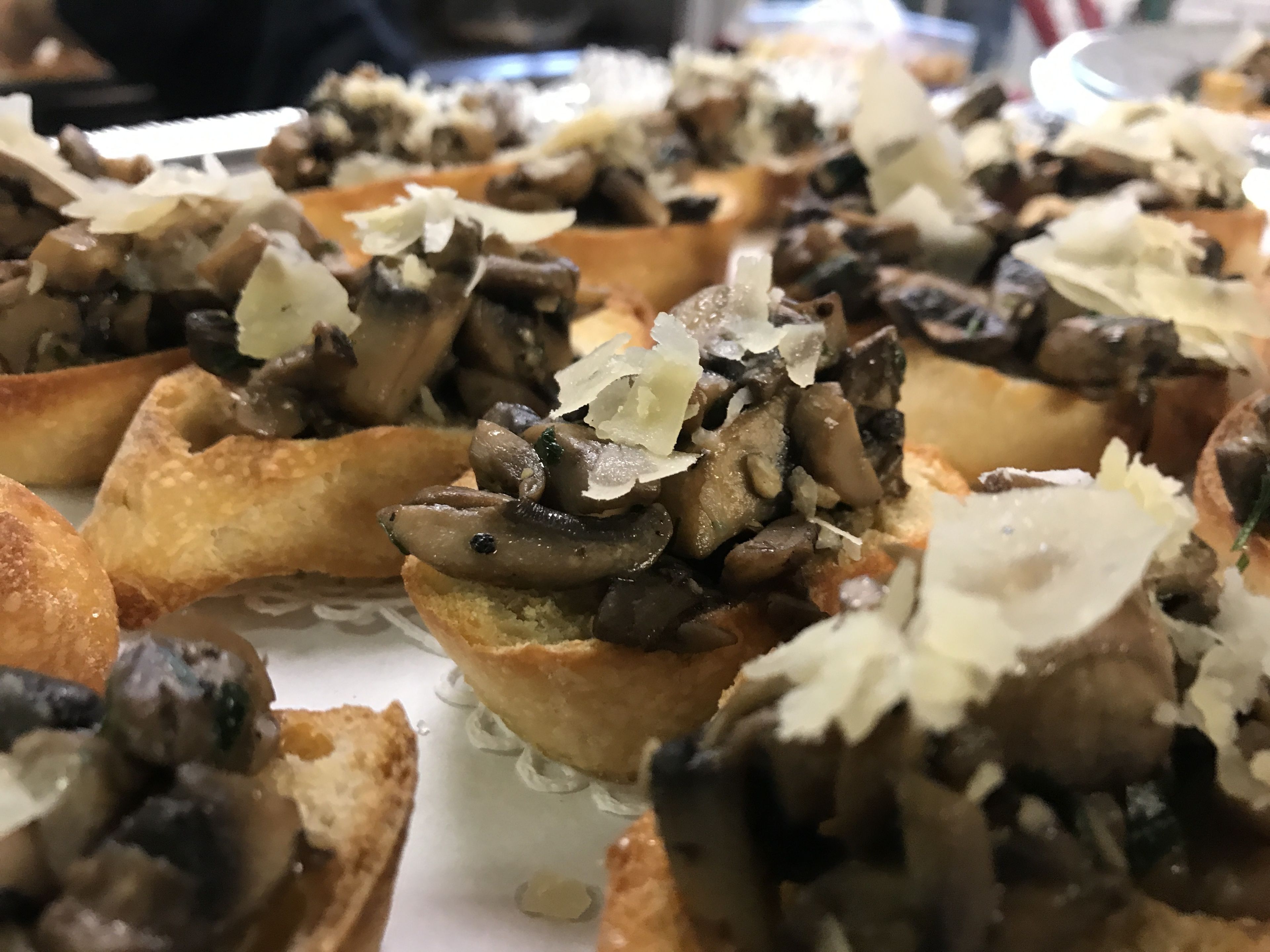 A close-up of a dish with mushrooms on a toasted base, possibly a type of appetizer or side dish.