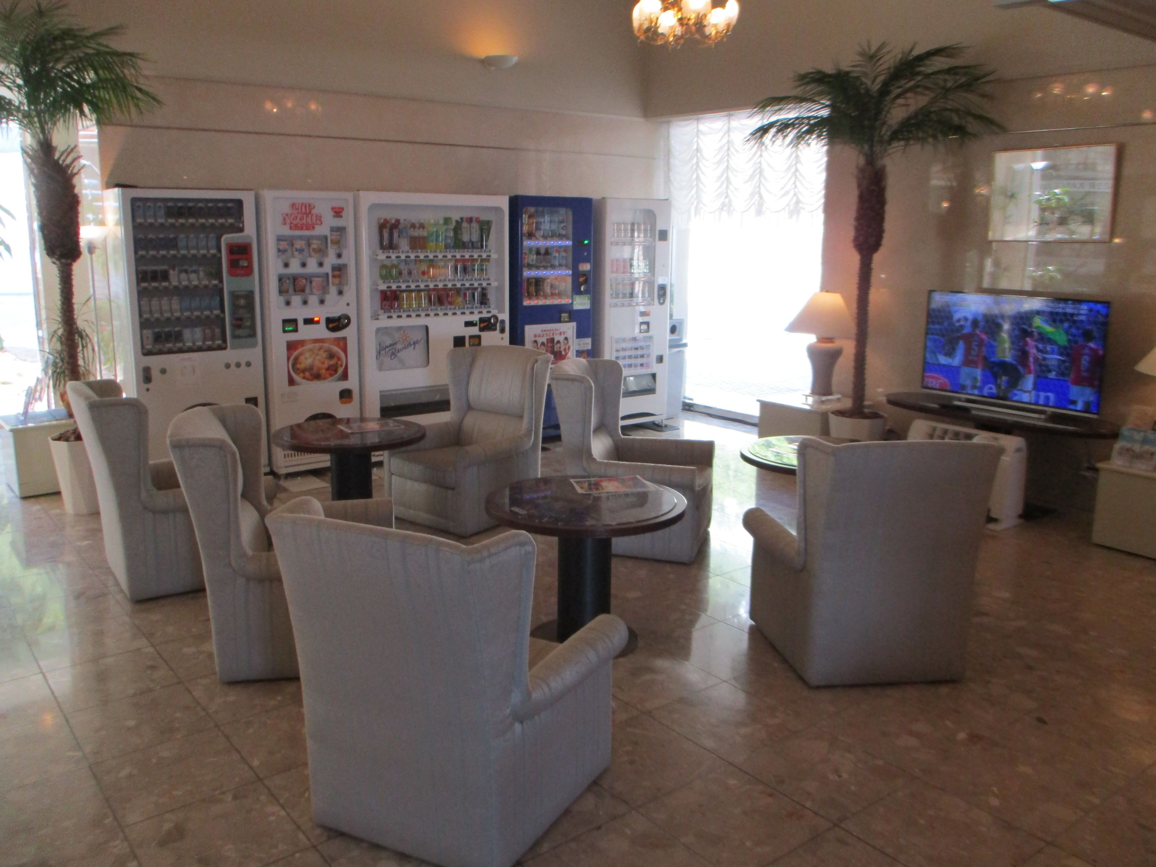 A lobby with seating, vending machines, and a TV.