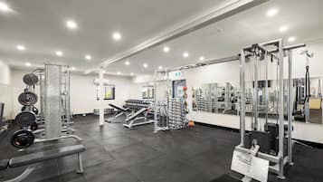 A gym with various exercise equipment, including weight machines and free weights.