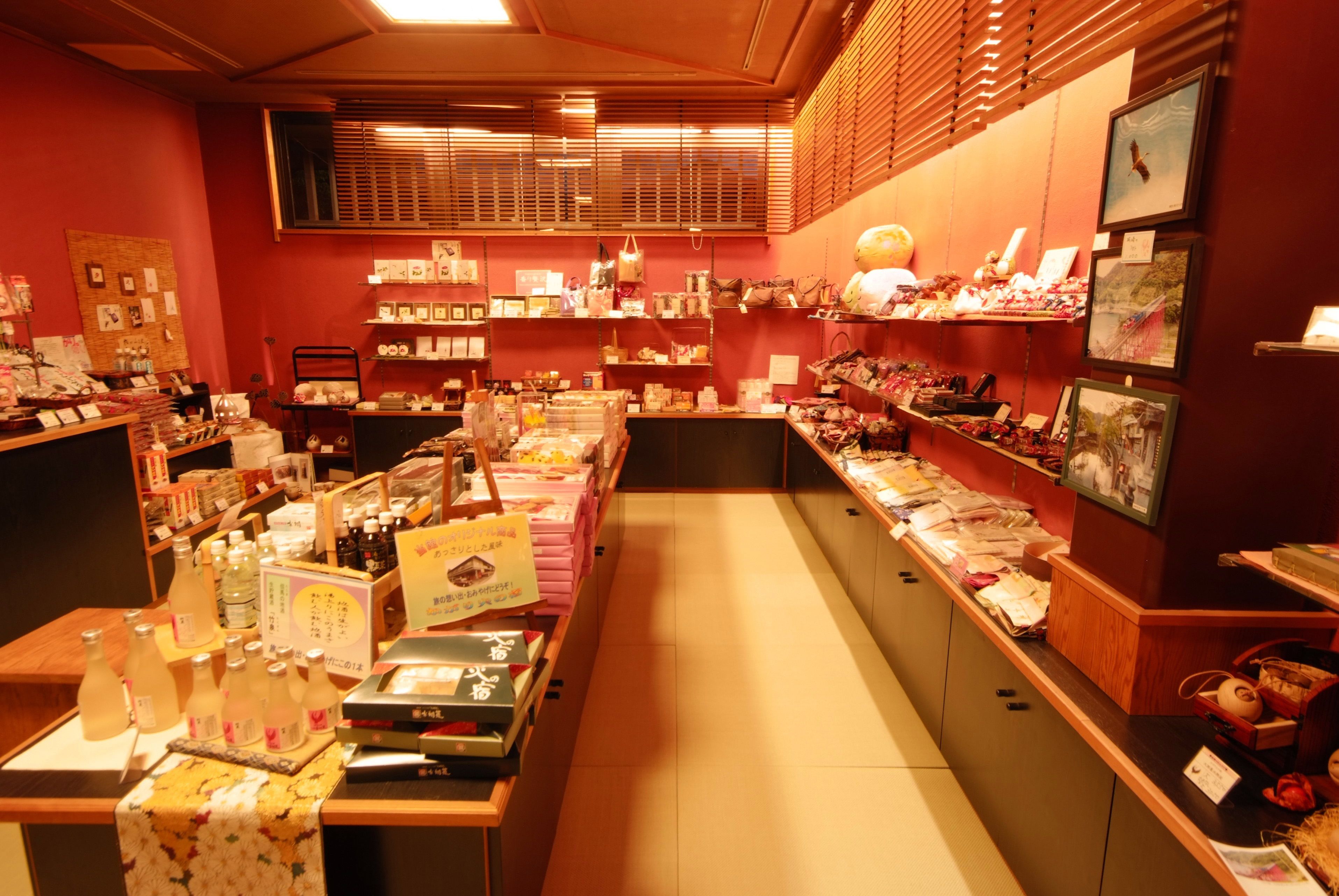 A well-organized store with various products on shelves and counters, including boxes, bottles, and decorative items.