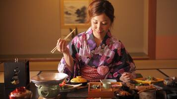 A traditional Japanese meal setup with various dishes and utensils.