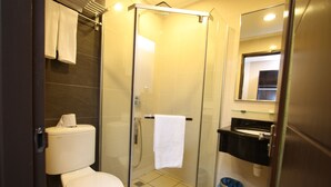 A modern bathroom with a glass-enclosed shower, a toilet, and a sink with a mirror above it. - 1 City Hotel (Kota Kinabalu)