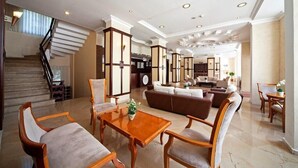 A spacious lobby with a staircase, seating area, and a reception desk. - Hotel Selen (Marmaris)