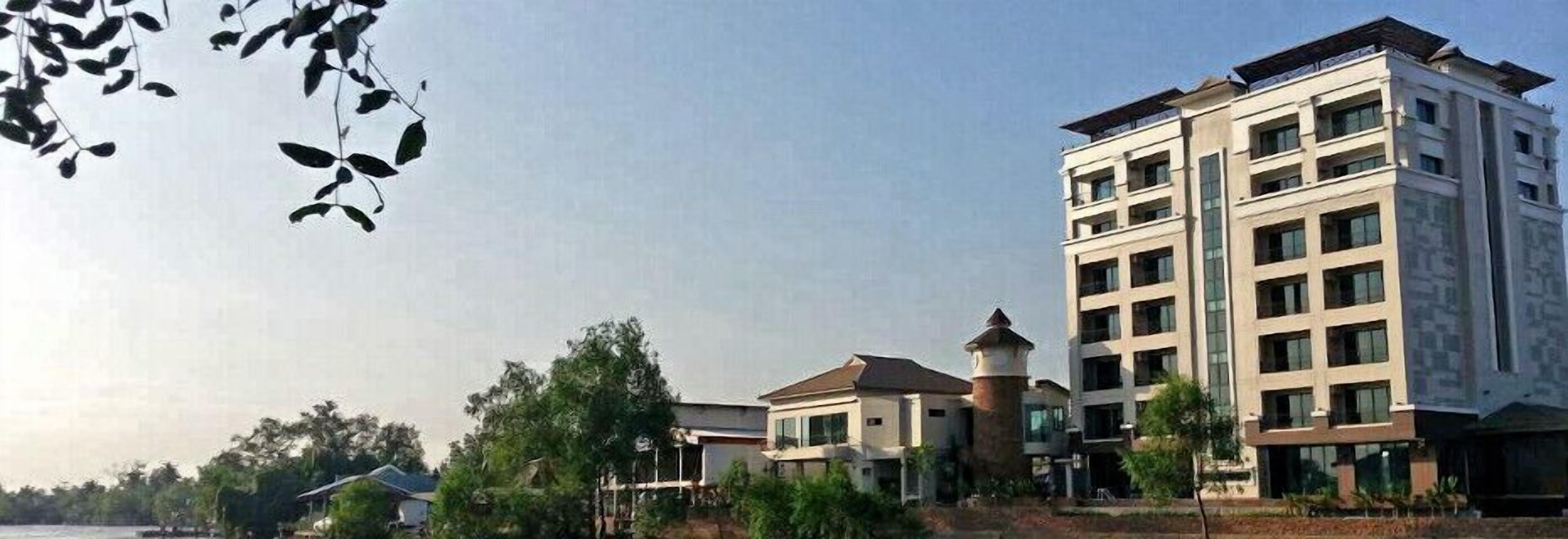 A multi-story hotel with a modern architectural design, featuring a prominent tower and multiple balconies.