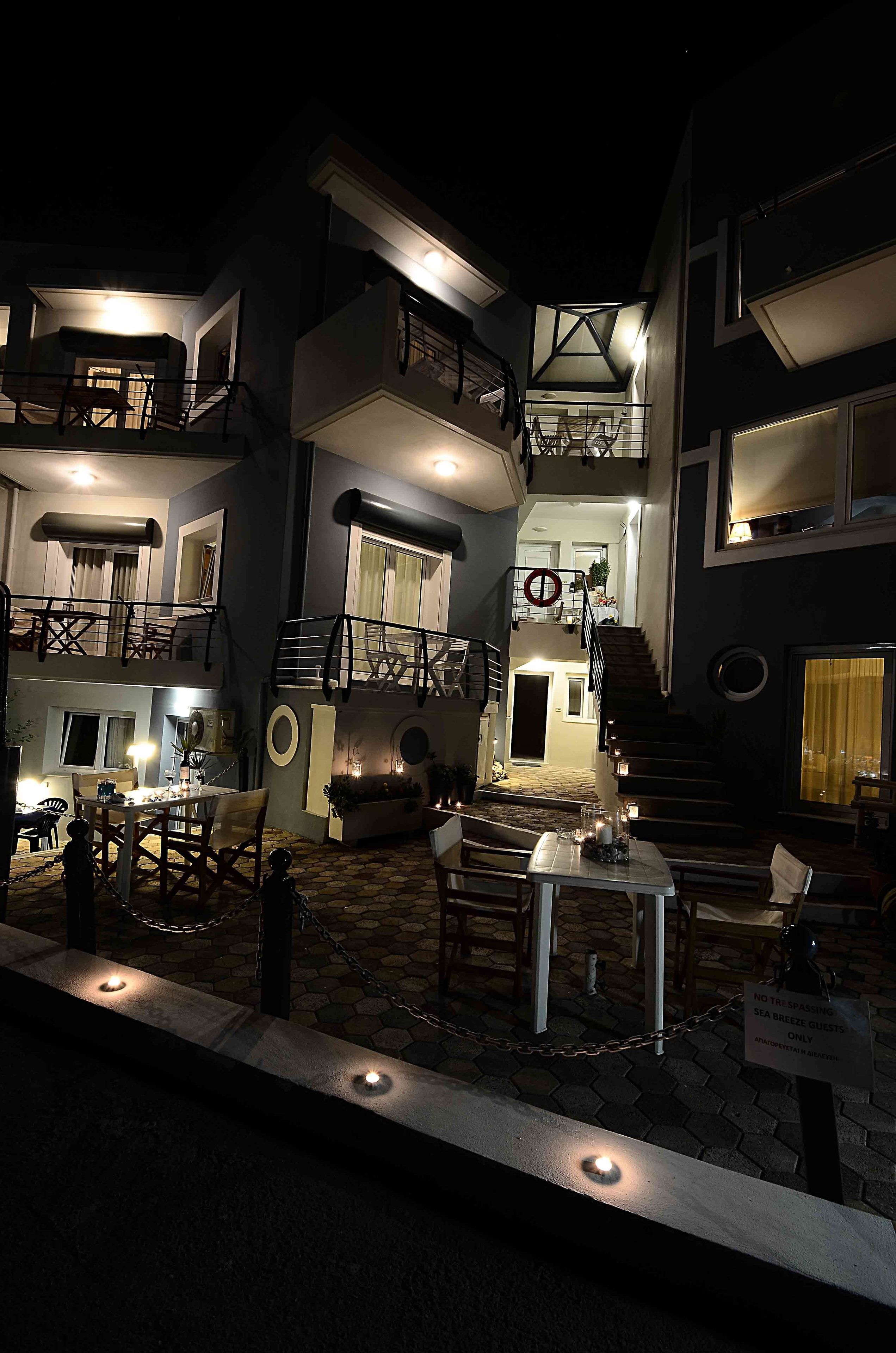 A multi-story building with outdoor seating and a staircase.