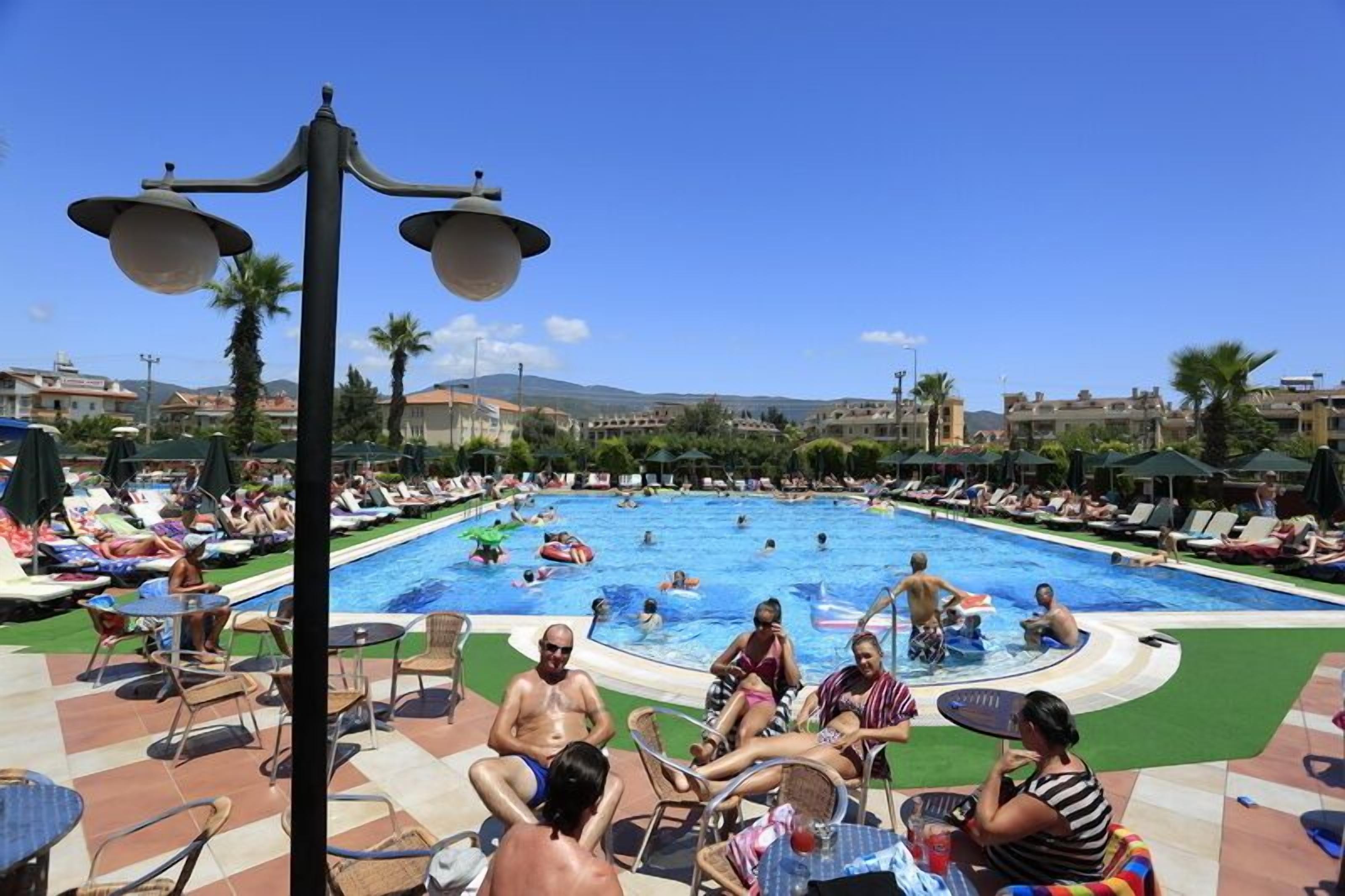 outdoor pool, open 8 am to 7 pm, pool umbrellas, pool loungers