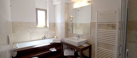 A modern bathroom with a bathtub, a sink, and a toilet.