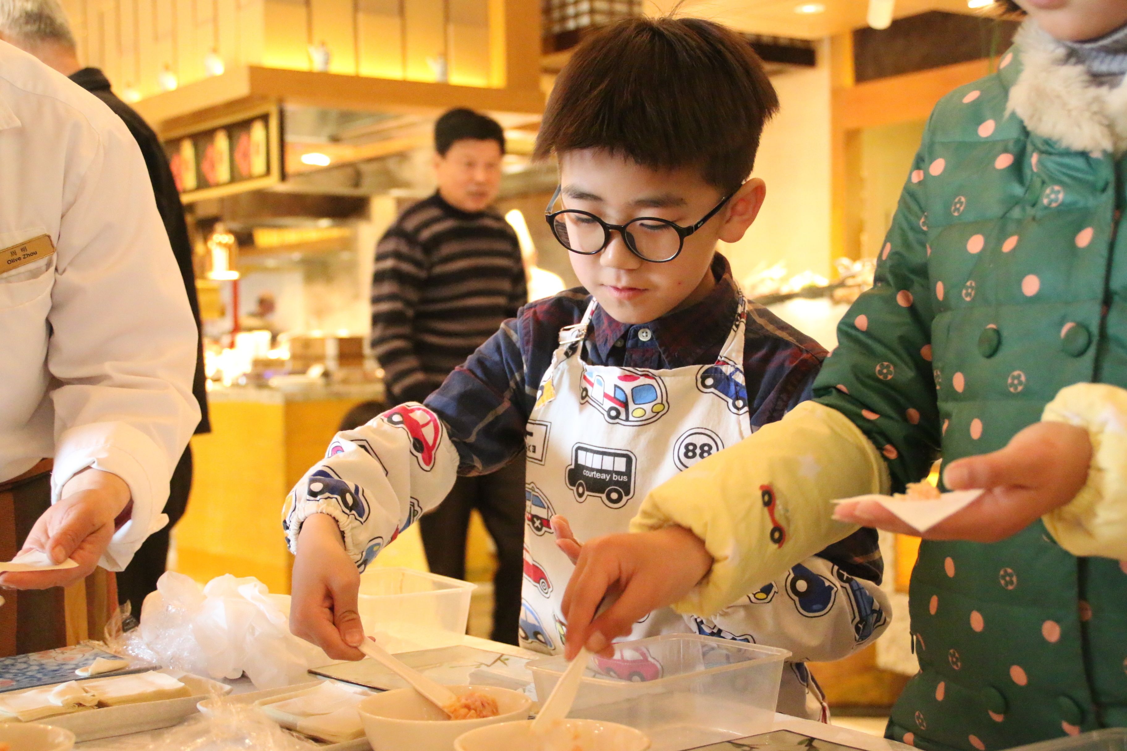 A person in a chef's uniform preparing food in a kitchen.