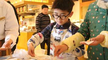 A person in a chef's uniform preparing food in a kitchen.