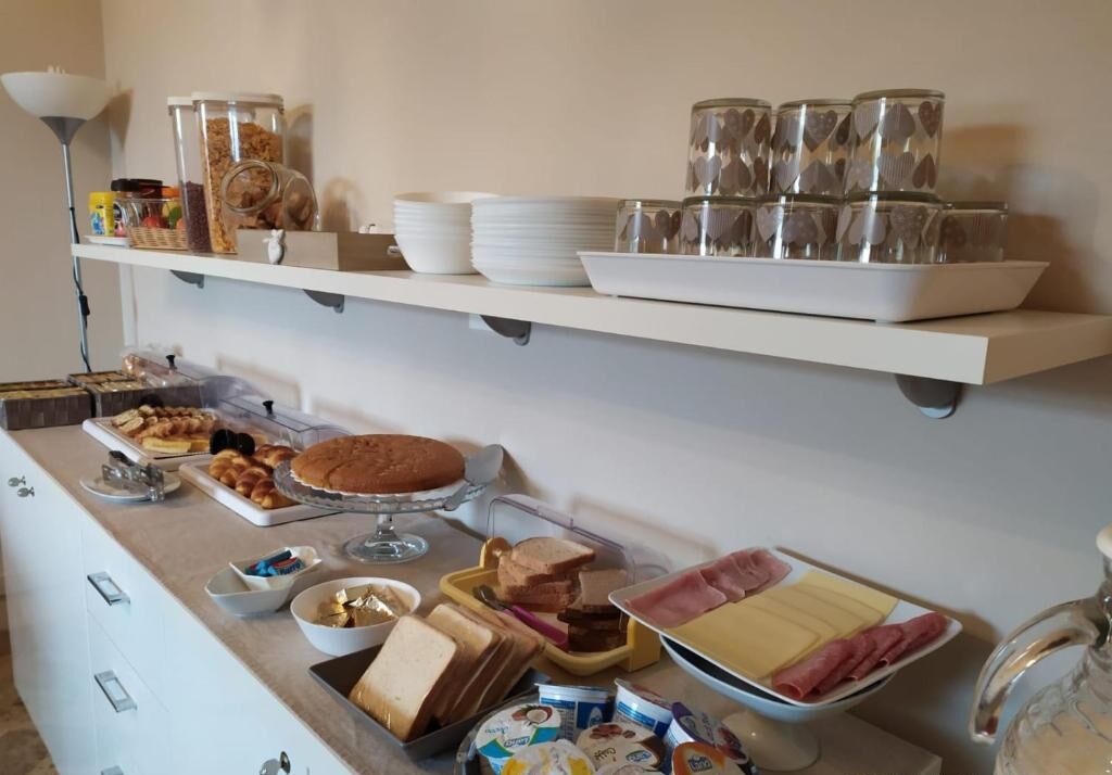 Disposição de buffet com diversos alimentos e utensílios.