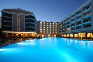 A hotel with a large indoor swimming pool, multiple balconies, and a modern architectural design. - Pasa Beach Hotel - All Inclusive (Marmaris)