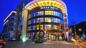 A modern hotel with a curved facade, large glass windows, and a prominent sign reading "Golden Rock Beach Hotel". - Golden Rock Beach Hotel - All Inclusive (Marmaris)