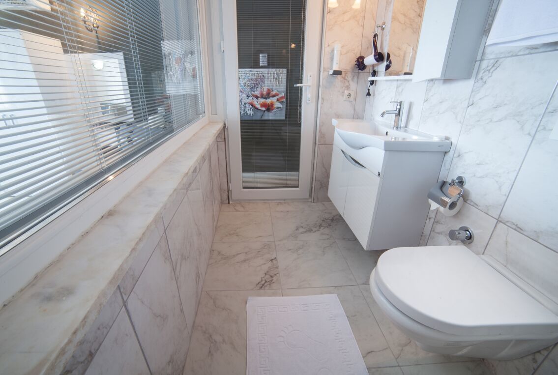 shower, hair dryer, slippers, towels