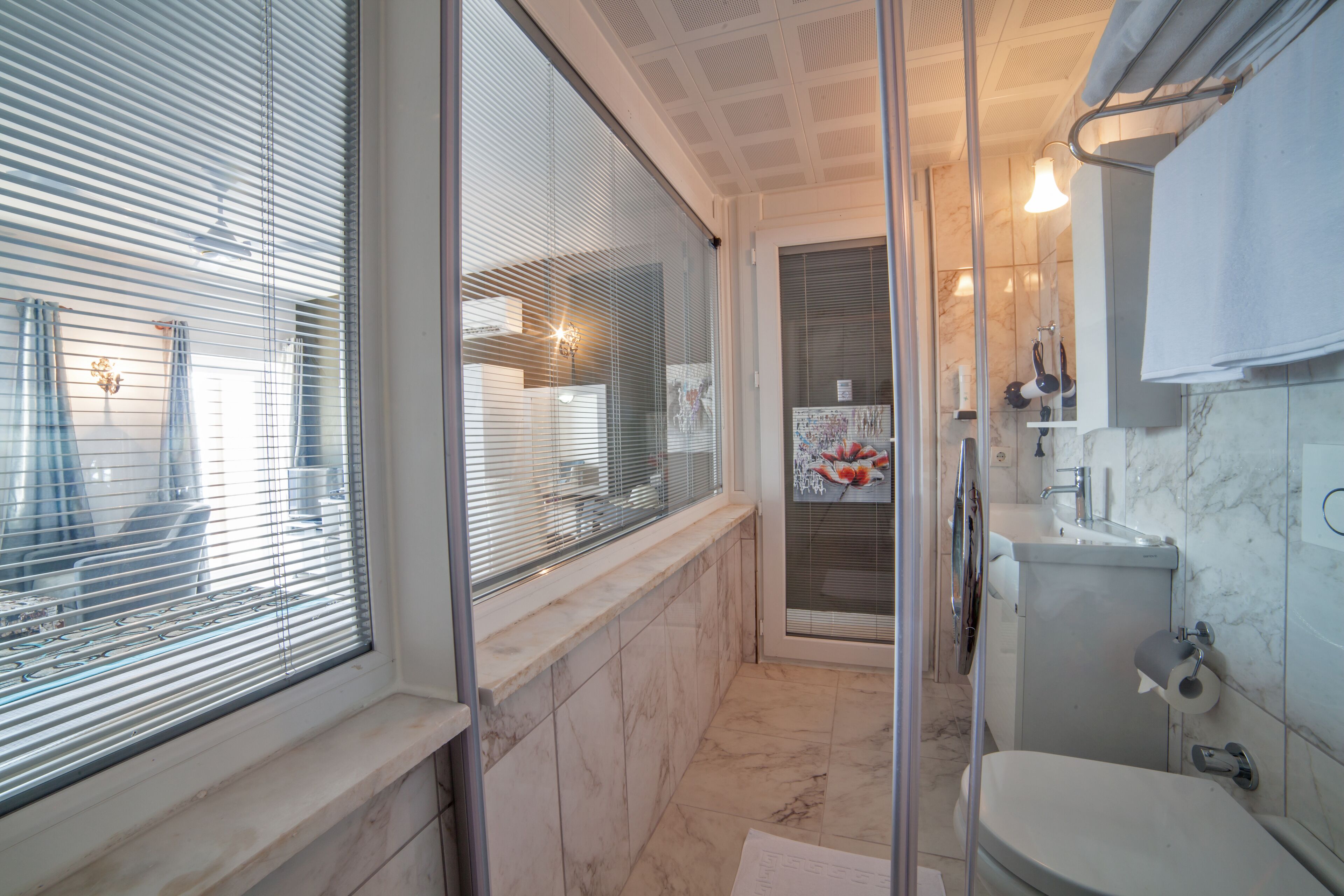 deluxe room | bathroom | shower, hair dryer, slippers, towels