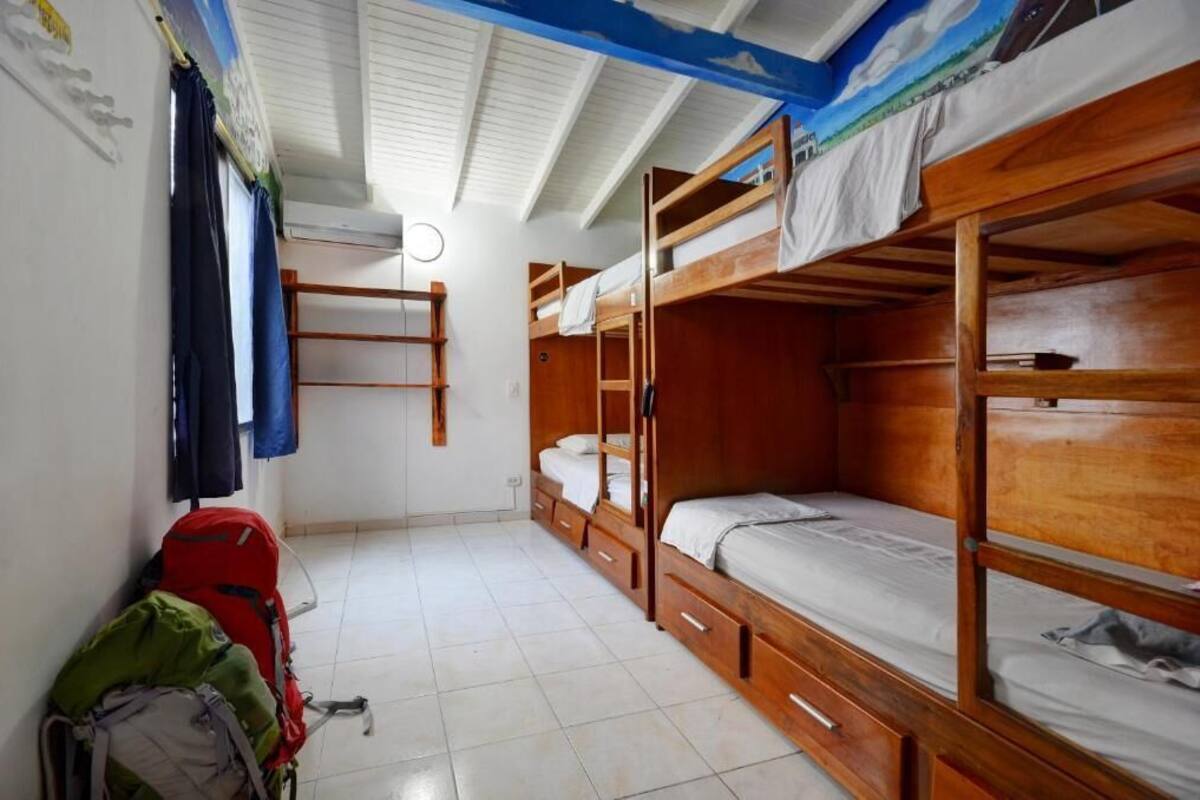 Un dormitorio con literas, un escritorio y una silla.