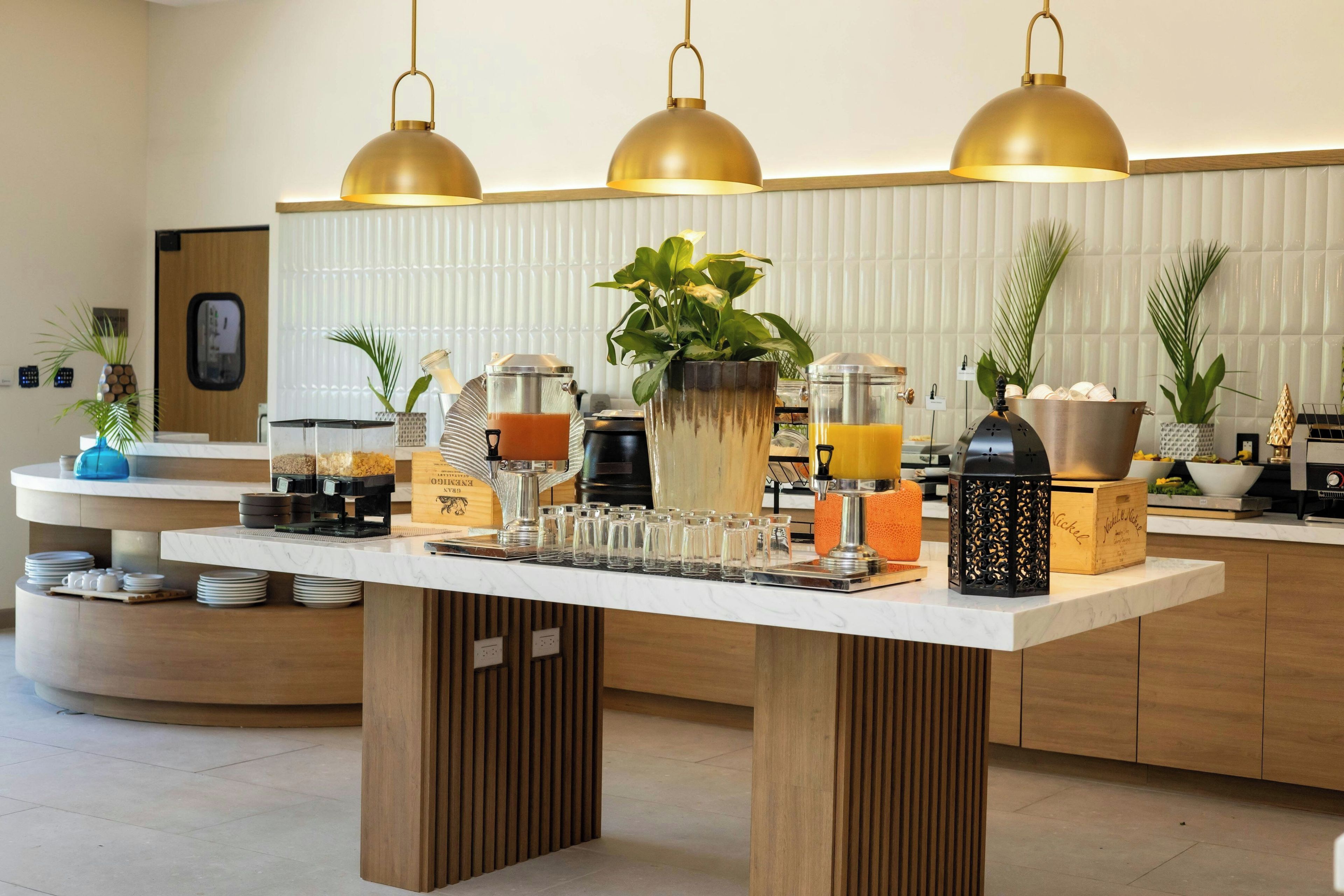 A breakfast bar with coffee machines, a fruit bowl, and a variety of breakfast items.