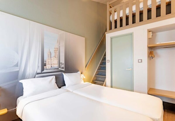 A bedroom with a bed, a window with a view, a door, and a staircase.