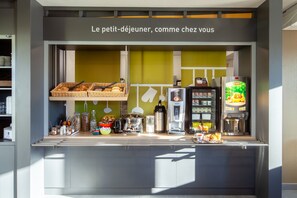 A breakfast bar with a variety of food items and a coffee machine. - B&B HOTEL Maurepas (Maurepas)