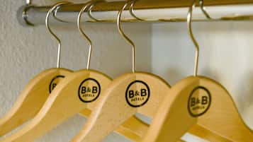 Wooden hangers with a logo on a metal rod.