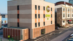 A modern hotel building with a sign indicating it is a B&B hotel.