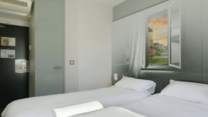 A hotel room with two single beds, a dark door with a light switch, and a window with a painting of a castle. - B&B HOTEL Le Mans Nord 1 (Saint-Saturnin)